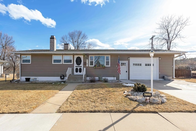 single story home featuring an attached garage, fence, concrete driveway, a chimney, and a front yard