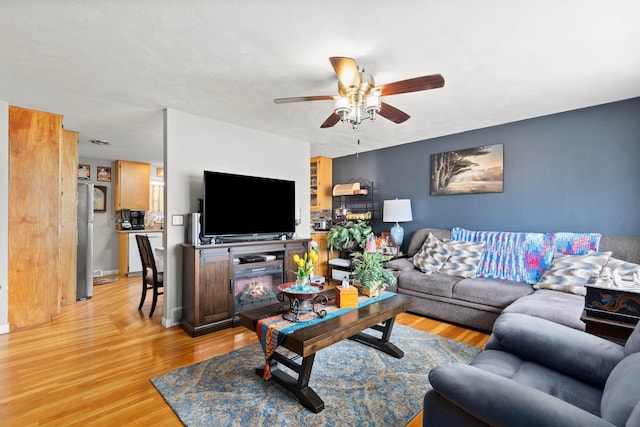 living room featuring ceiling fan and light wood-style flooring