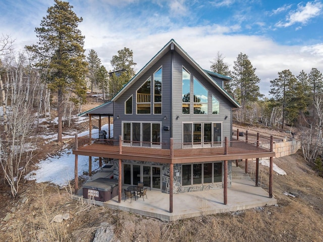 rear view of house with a deck, stairway, and a patio area