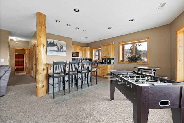 game room featuring recessed lighting, light carpet, and a textured ceiling