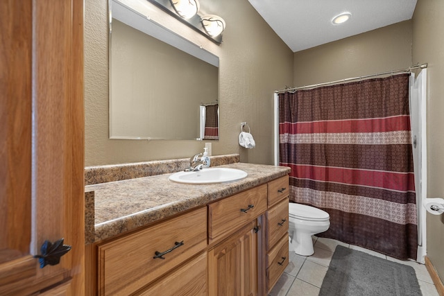 bathroom featuring a textured wall, toilet, a shower with curtain, tile patterned floors, and vanity