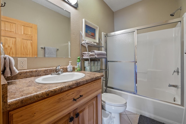 full bath with toilet, shower / bath combination with glass door, tile patterned flooring, and vanity