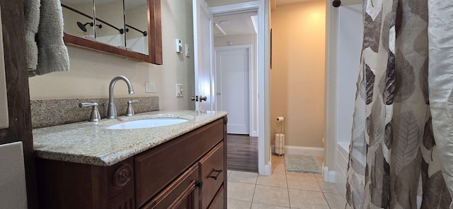 bathroom featuring baseboards, vanity, and tile patterned floors