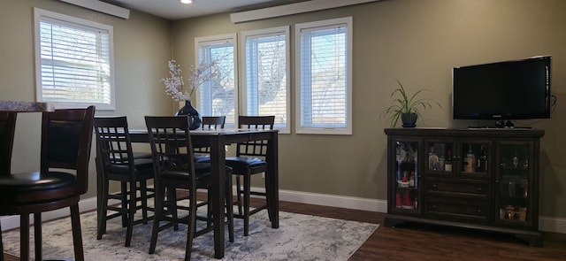 dining space featuring plenty of natural light, baseboards, wood finished floors, and recessed lighting