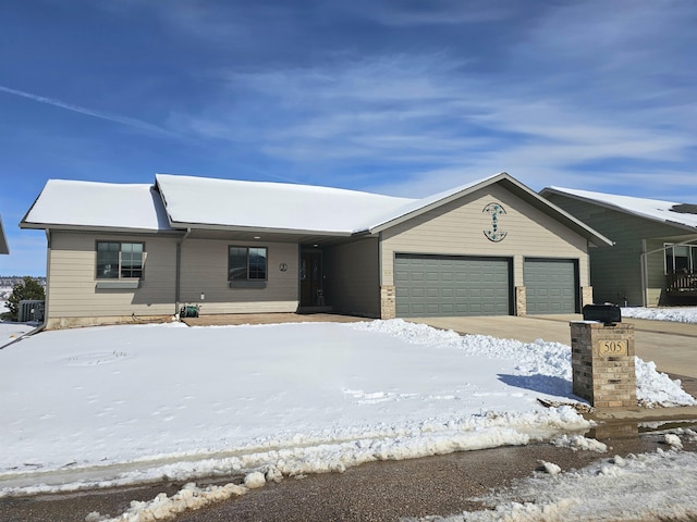 ranch-style home with a garage and central AC