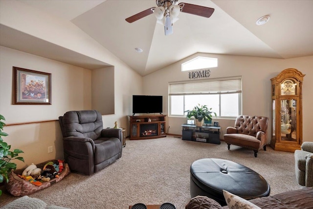 living room featuring lofted ceiling, carpet, a warm lit fireplace, and ceiling fan