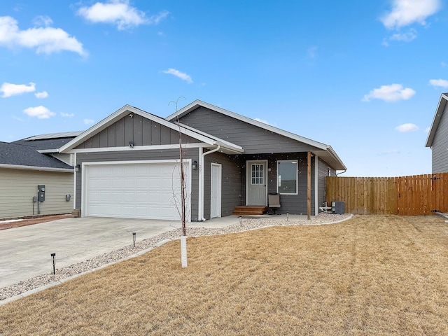 ranch-style house with central air condition unit, an attached garage, board and batten siding, fence, and driveway