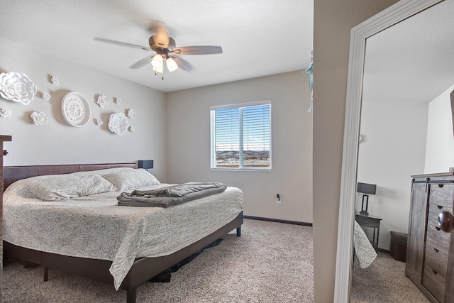 carpeted bedroom with a ceiling fan and baseboards