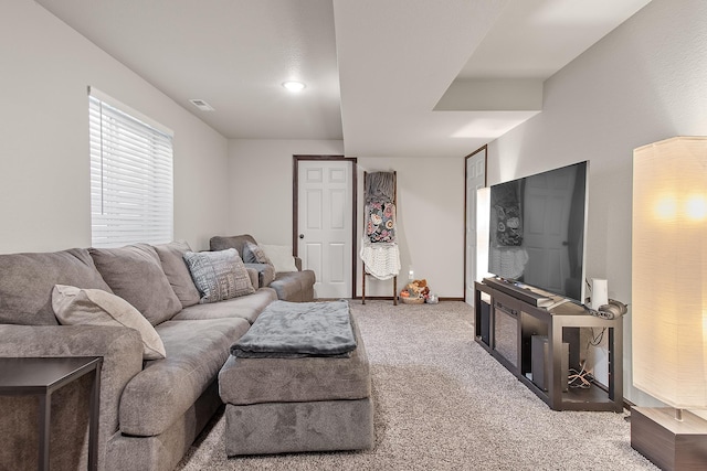 living area with visible vents and carpet flooring