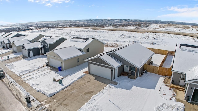 snowy aerial view featuring a residential view