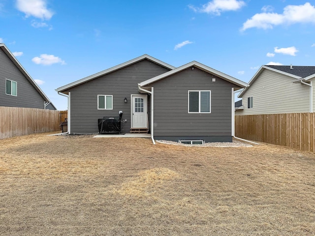 back of property featuring a fenced backyard