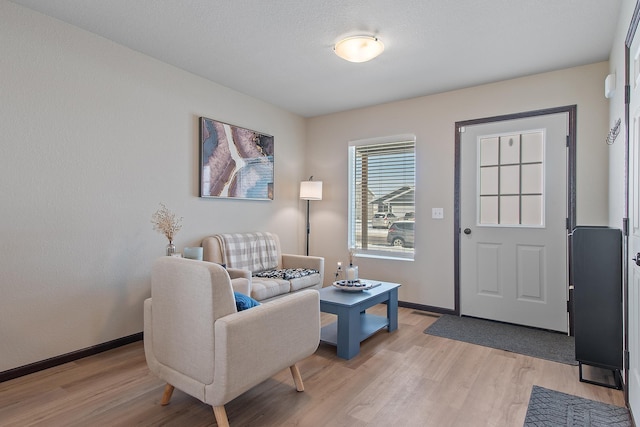 interior space featuring light wood-style floors and baseboards