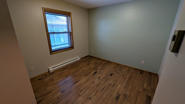 unfurnished room with baseboard heating, wood-type flooring, and baseboards