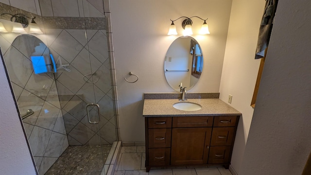 bathroom with a shower stall and vanity