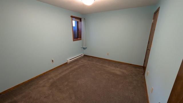 spare room featuring a textured ceiling, baseboards, baseboard heating, and carpet flooring