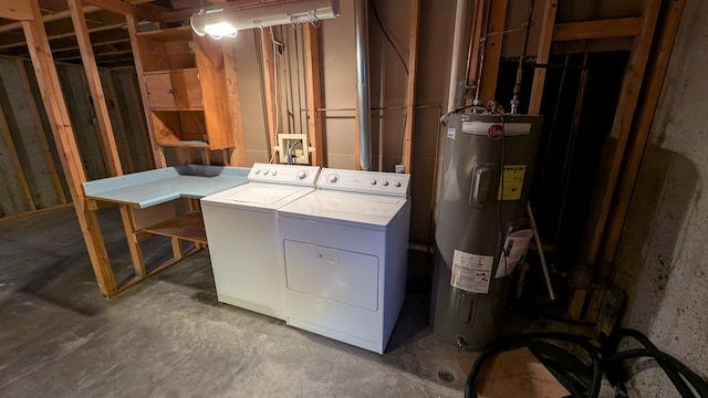 washroom with washing machine and dryer, laundry area, and electric water heater