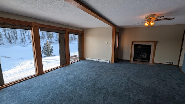 unfurnished living room with a healthy amount of sunlight, a baseboard radiator, a fireplace, and visible vents