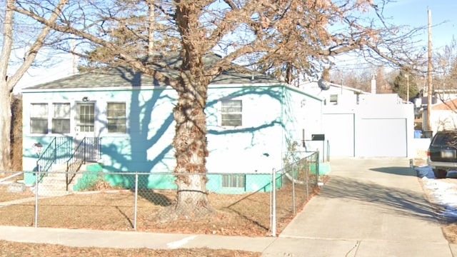 view of home's exterior with a garage, a fenced front yard, and concrete driveway