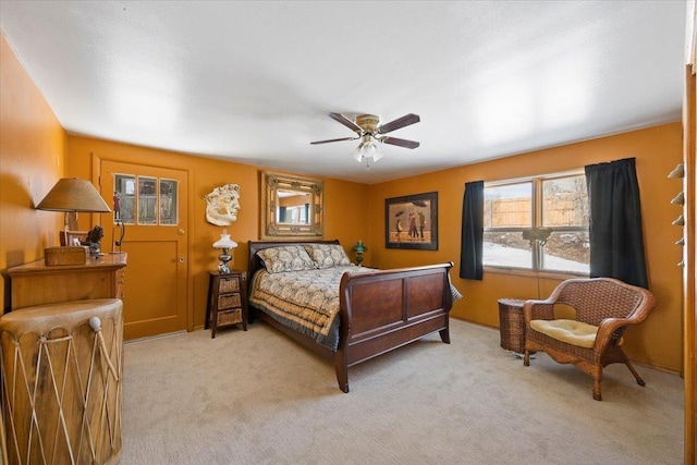 bedroom with light carpet and a ceiling fan