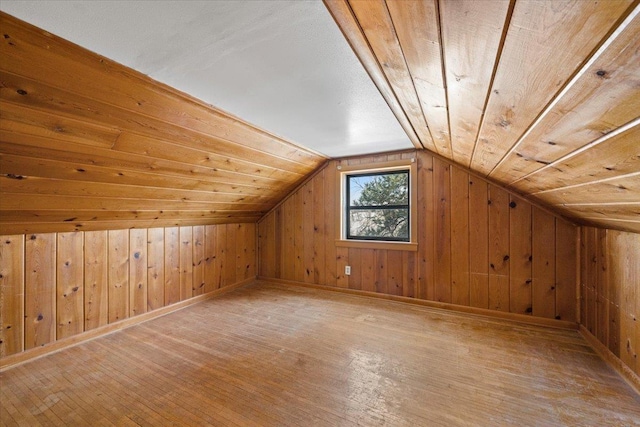 bonus room featuring wood walls, wood ceiling, vaulted ceiling, and hardwood / wood-style floors