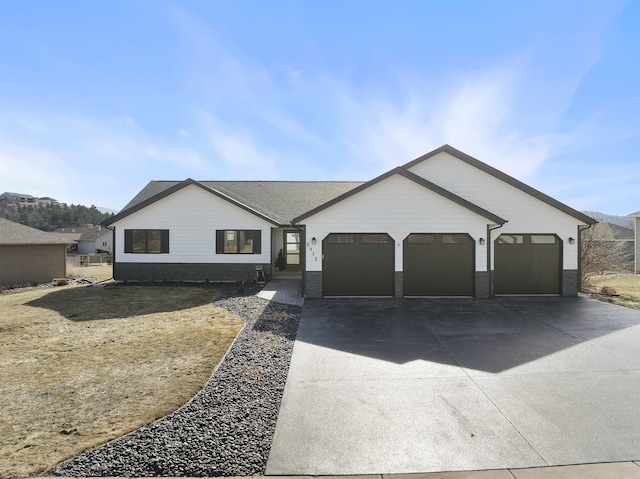 ranch-style house with driveway and an attached garage