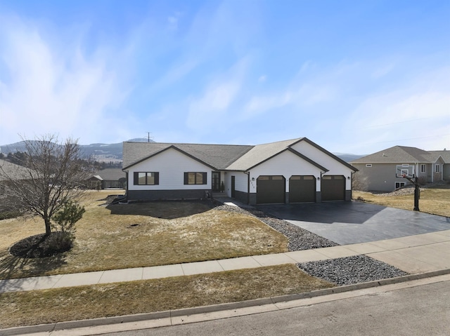 ranch-style house with concrete driveway and an attached garage