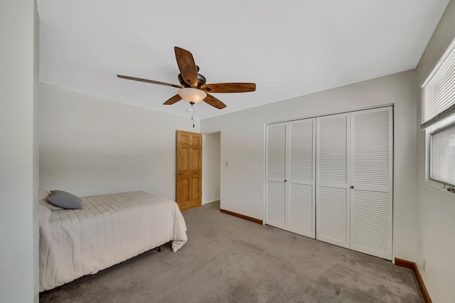 bedroom featuring a closet, carpet floors, baseboards, and ceiling fan