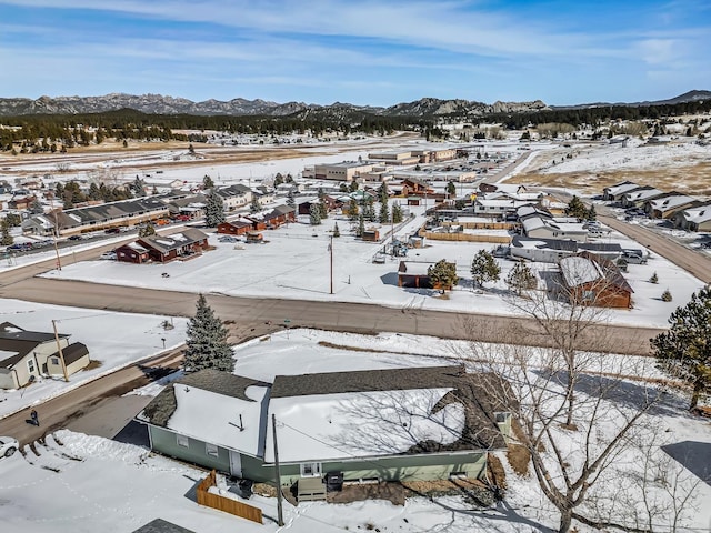 snowy aerial view with a mountain view