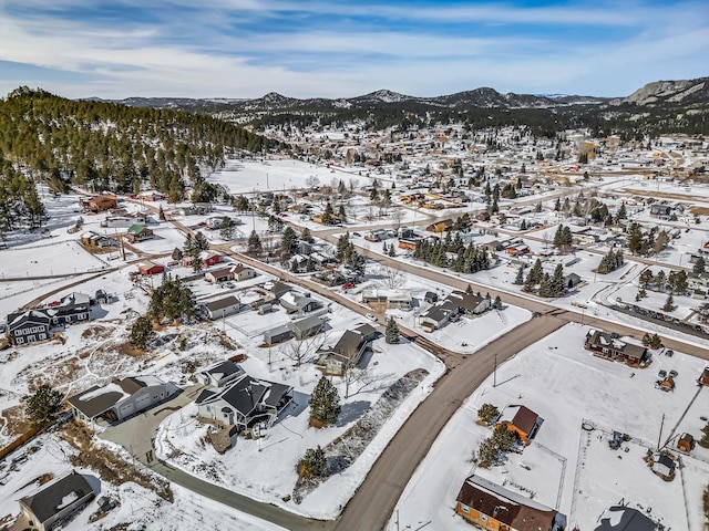 snowy aerial view featuring a mountain view