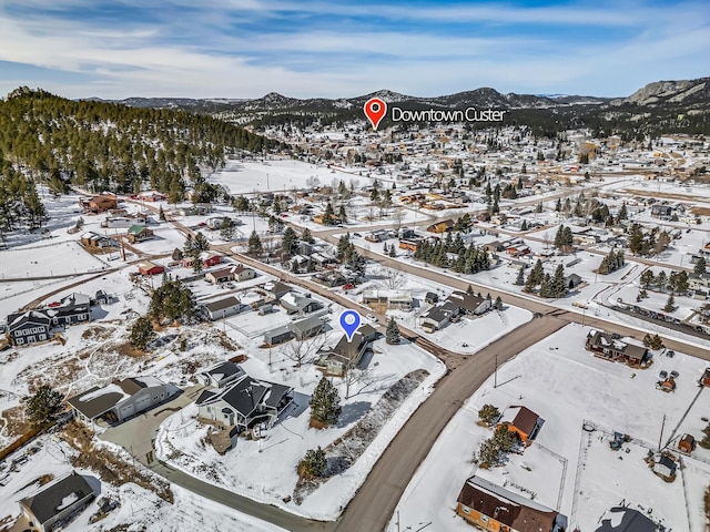 snowy aerial view with a mountain view