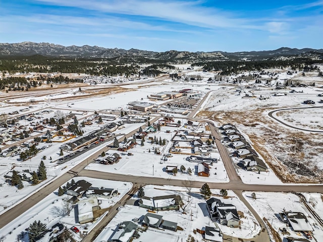 snowy aerial view featuring a mountain view