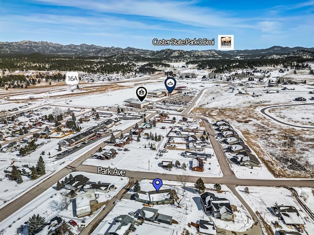 snowy aerial view with a mountain view