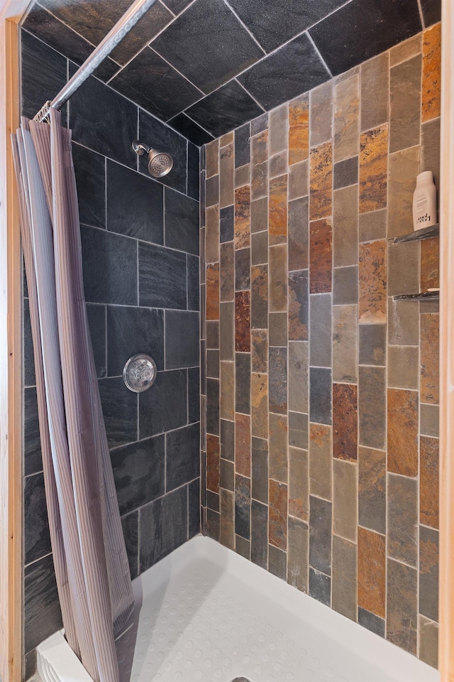 bathroom with a tile shower