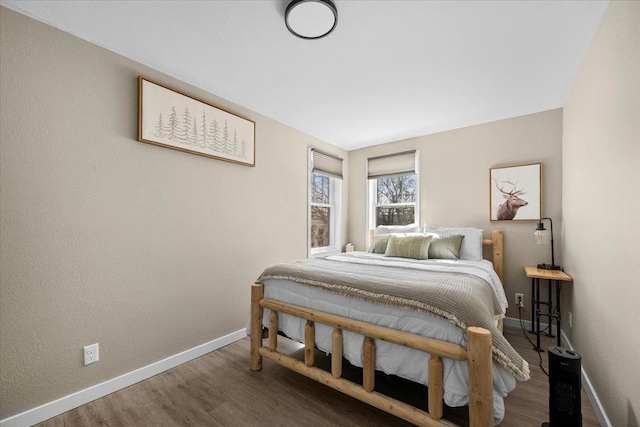 bedroom featuring baseboards and wood finished floors