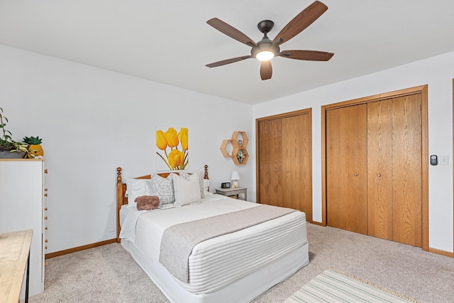 3418 Gray Fox Ct, Rapid City, SD 57701 - bedroom with baseboards, multiple closets, light colored carpet, and a ceiling fan