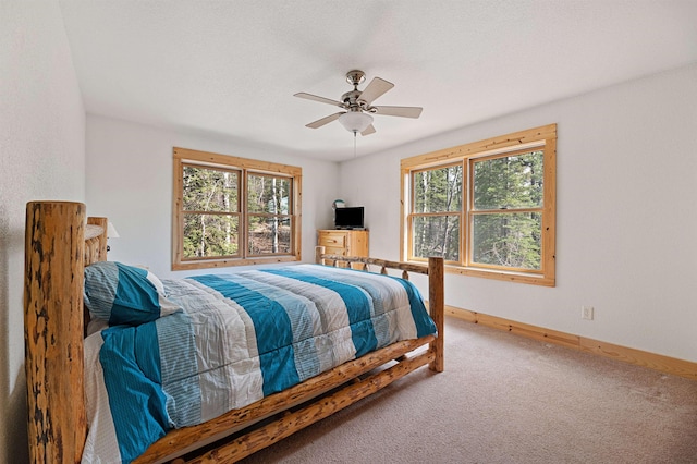 bedroom with baseboards, carpet, and a ceiling fan