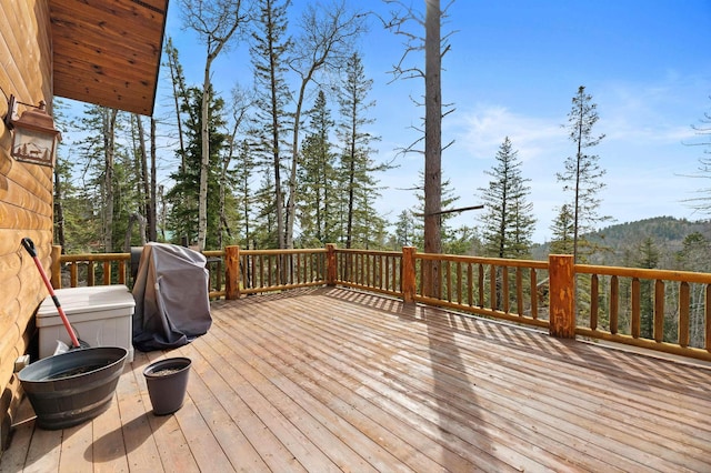 wooden terrace featuring a grill