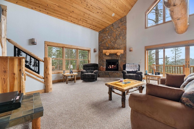 carpeted living area featuring stairway, baseboards, high vaulted ceiling, a fireplace, and wooden ceiling