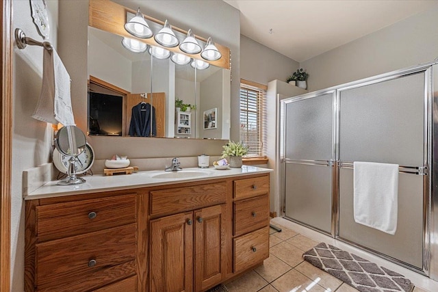 bathroom featuring tile patterned floors, a stall shower, and vanity