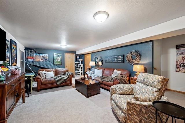 living area with baseboards, carpet, and a textured ceiling