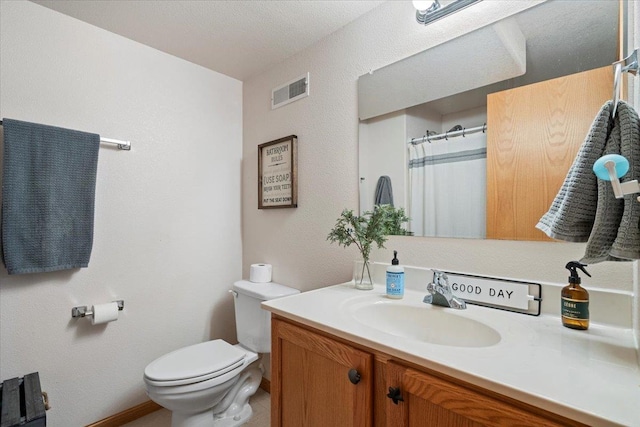 bathroom with visible vents, toilet, and vanity