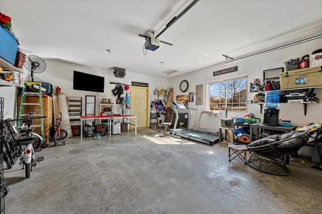 garage with electric panel, a workshop area, and a garage door opener