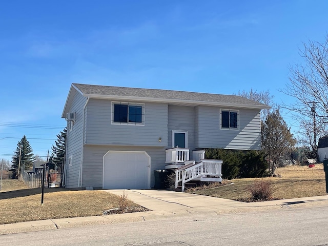 split foyer home with an attached garage and driveway