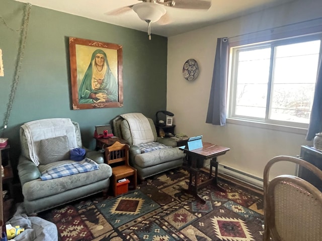 living area featuring a ceiling fan, baseboards, and a baseboard radiator