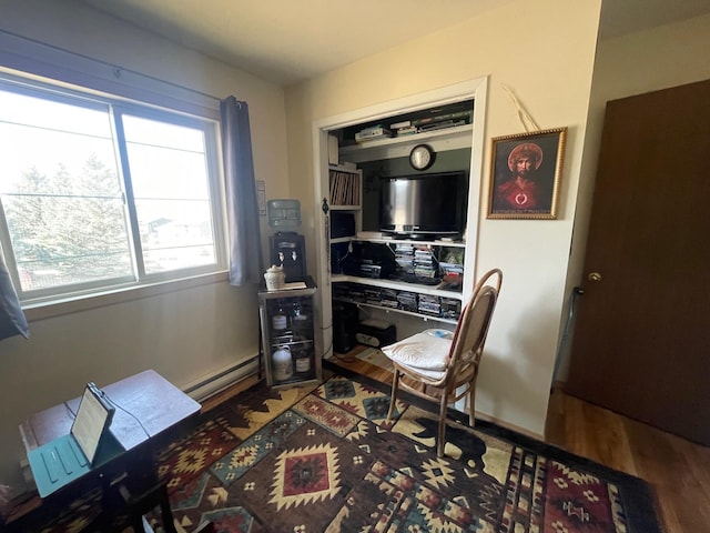 office featuring baseboard heating and wood finished floors