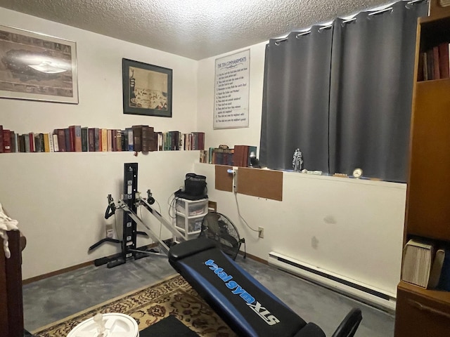 workout area featuring a textured ceiling, baseboards, and a baseboard radiator