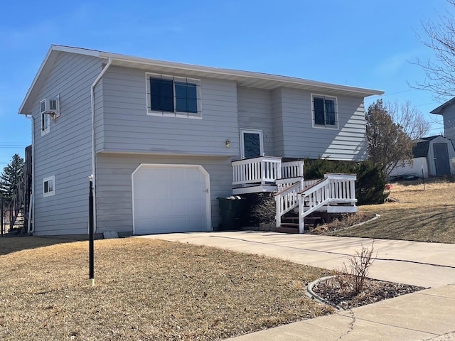 rear view of house featuring an attached garage and driveway