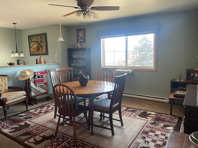 carpeted dining room featuring baseboard heating and a ceiling fan