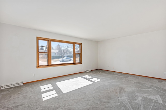 unfurnished room with visible vents, carpet flooring, and baseboards