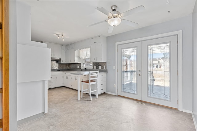 kitchen featuring visible vents, a ceiling fan, tasteful backsplash, white cabinetry, and french doors